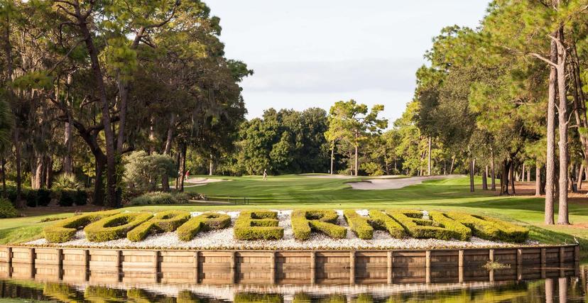 Copperhead spelt out in bushes on its course with smooth green and sand bunker in the background