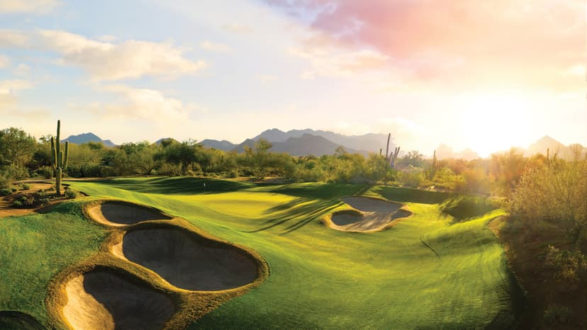 Sun setting over the Grayhawk course illuminating a well-maintained green