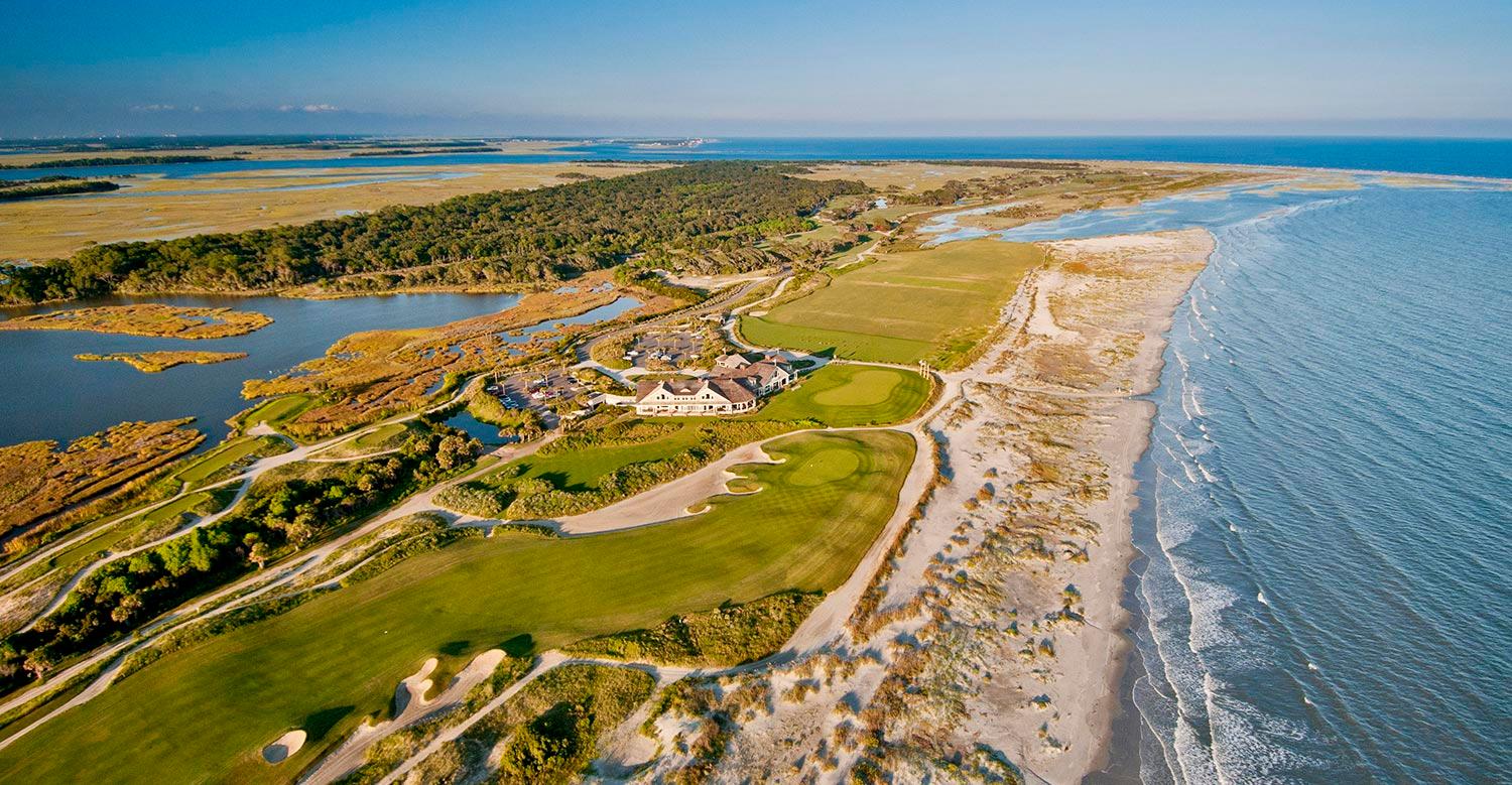 A breathtaking aerial shot of the ocean course nestled between water and sandy beaches.