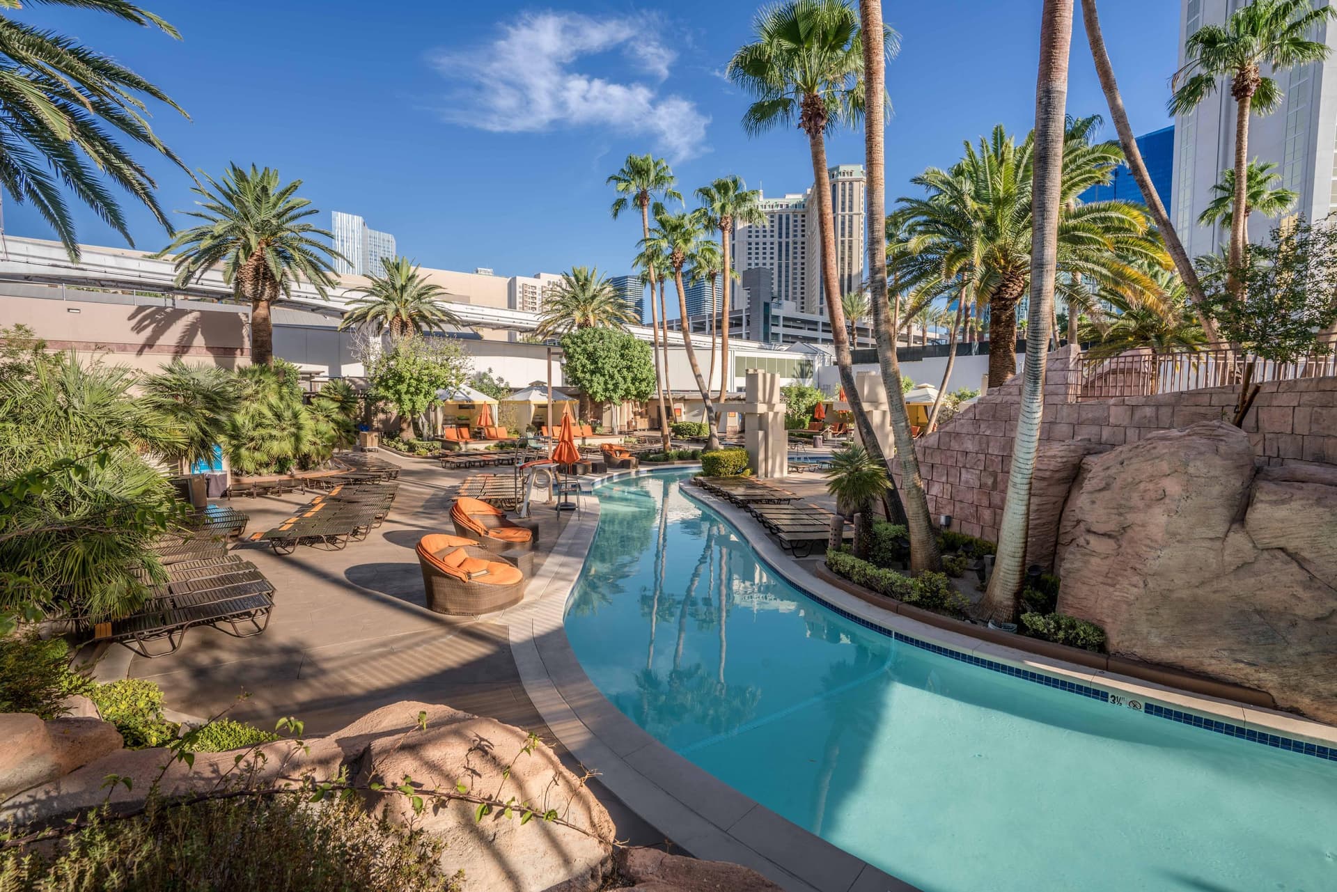 The cities ski scrapers looking over the outdoor lazy river designed swimming pool at the resort
