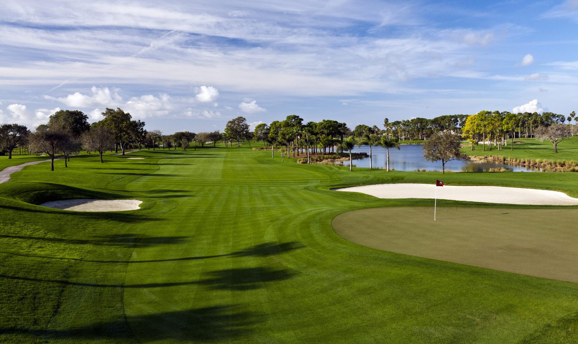 Wide straight fairway leading to well-maintained green neighbouring a large sand bunker