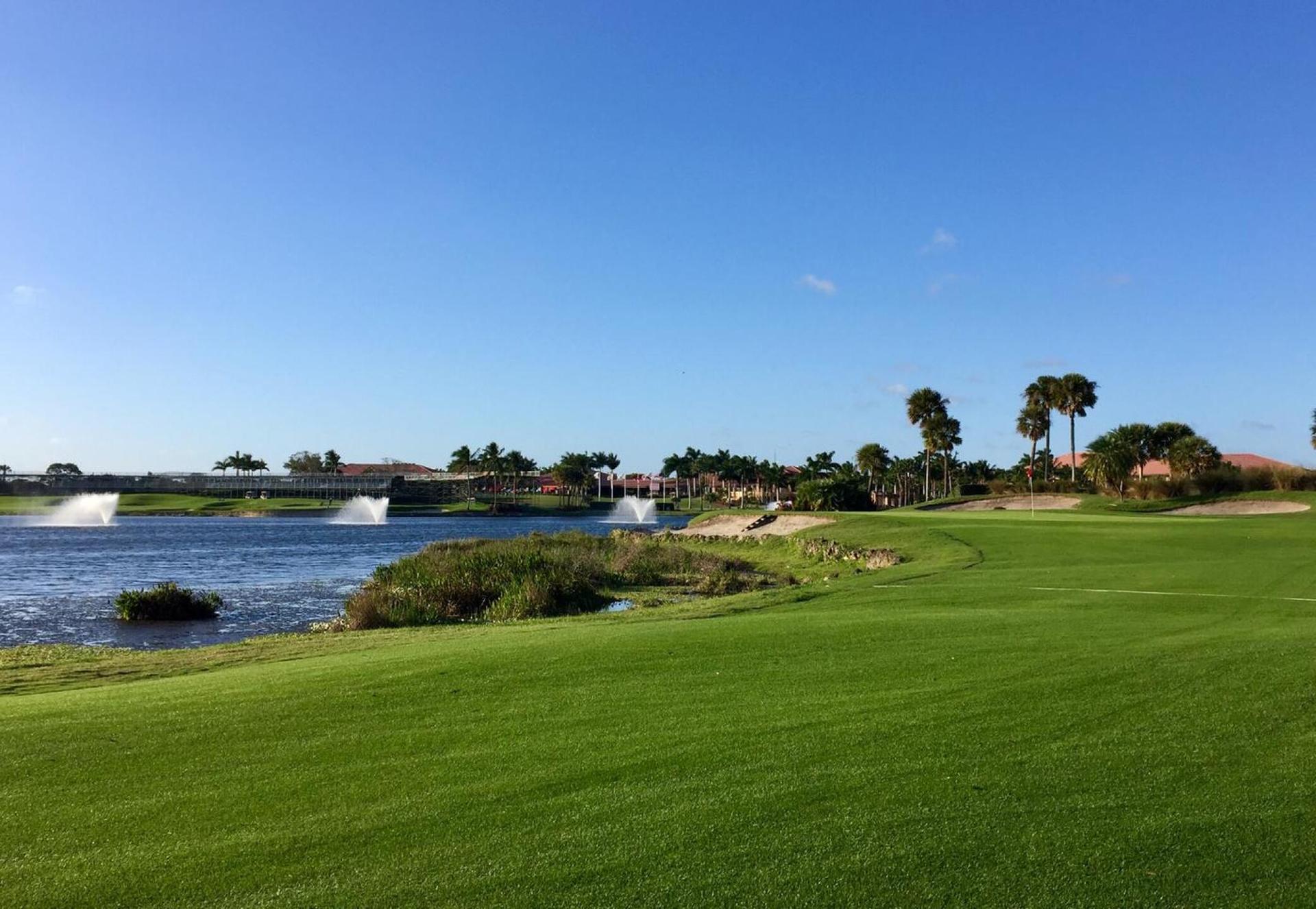 Well maintained fairway leading to a green neighbouring a water hazard equipped with water fountains