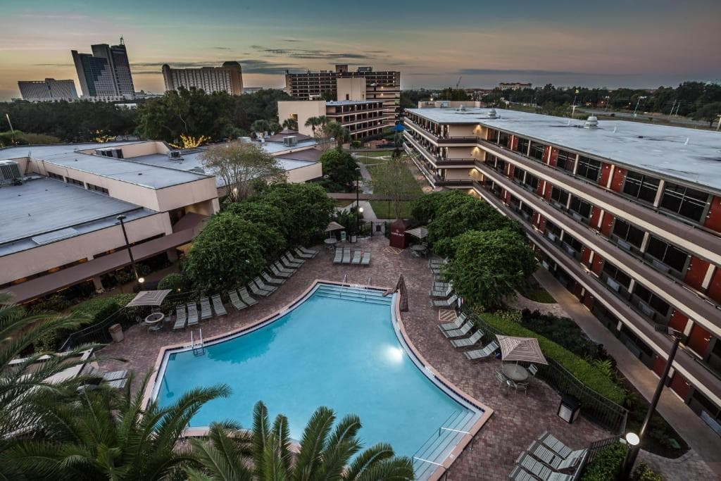 Aerial view of the hotel at evening shows the Rosen Inn building and swimming pool