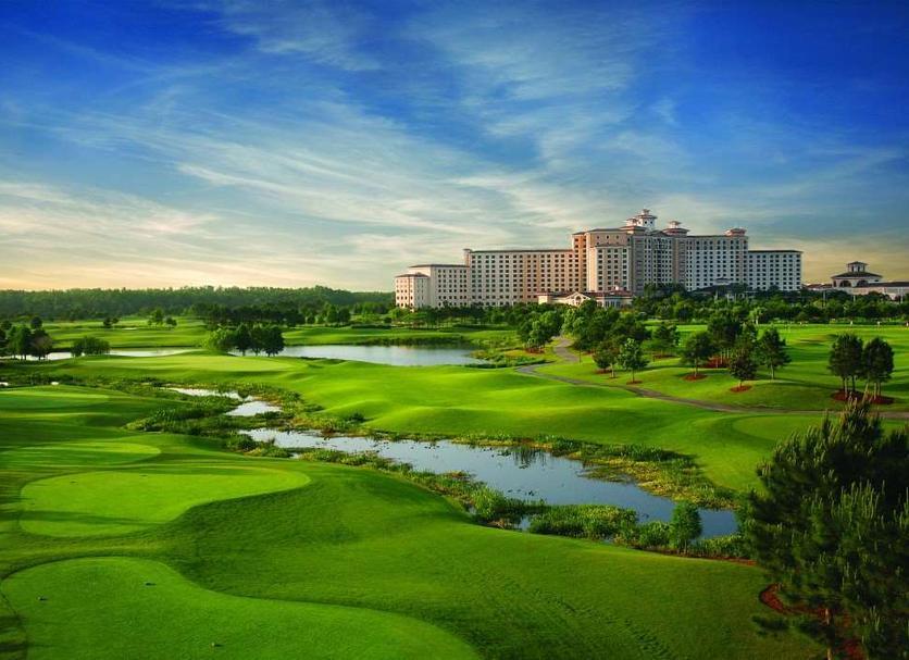 Wide angle view of the golf course leading towards the resort building