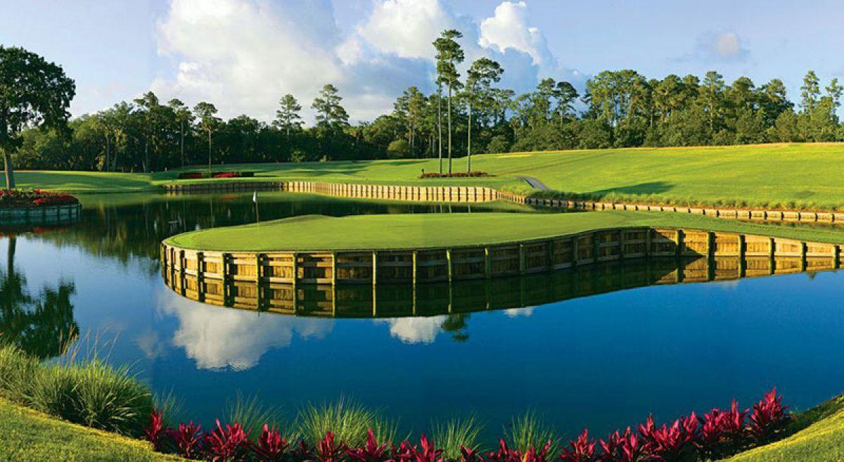 Green elevated from a water hazard by a wooden wall at the on sight course