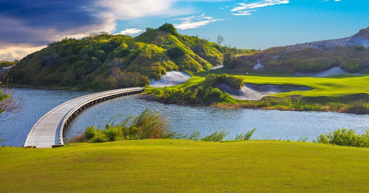 Bridge leading to a green strategically placed on a mountainous island