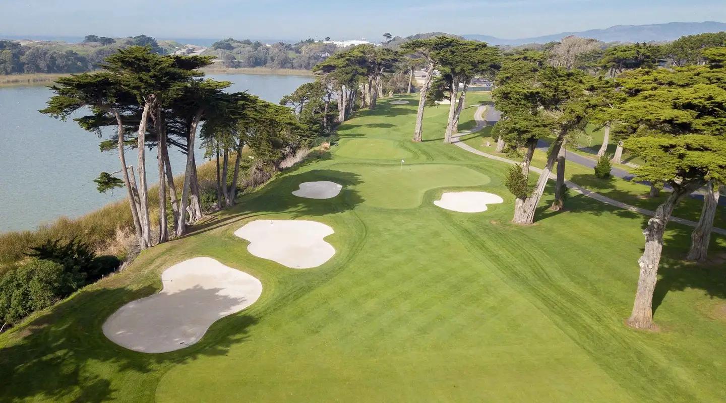 A fairway surrounded by sand bunkers with coastal views