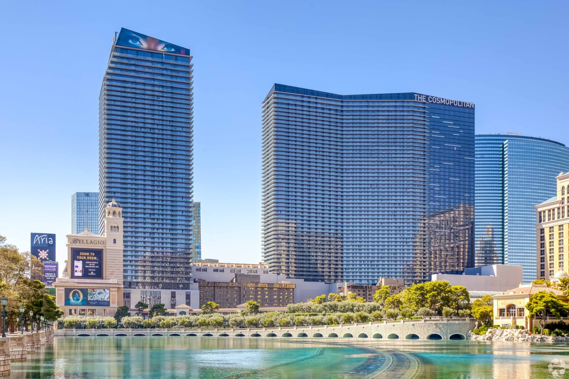 Panoramic view of the Cosmopolitan sky scraper building towering over a small lake
