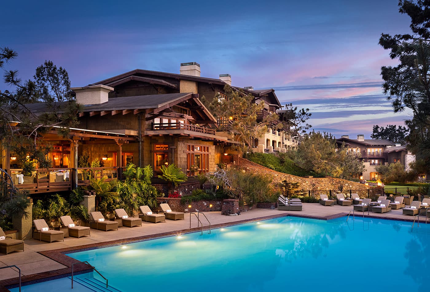 Exterior view of The Lodges clubhouse looking over their outdoor swimming pool