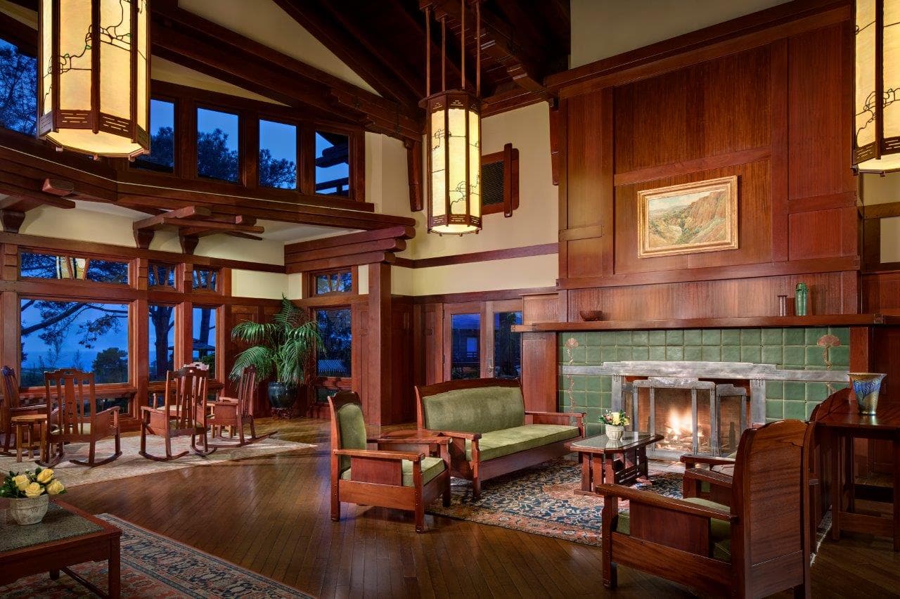 Indoor lounging area at the resort with high ceilings and a fire place