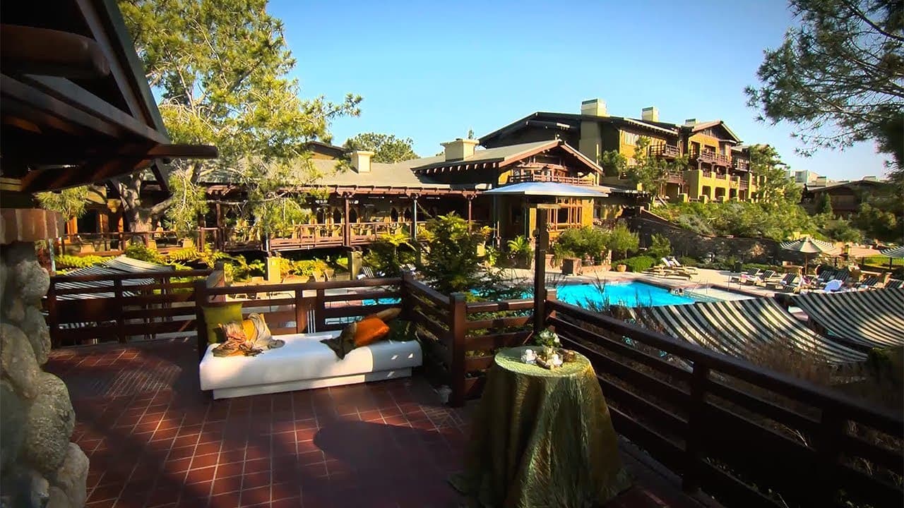 Balcony views of the outdoor swimming pool featuring sun beds under blue skies