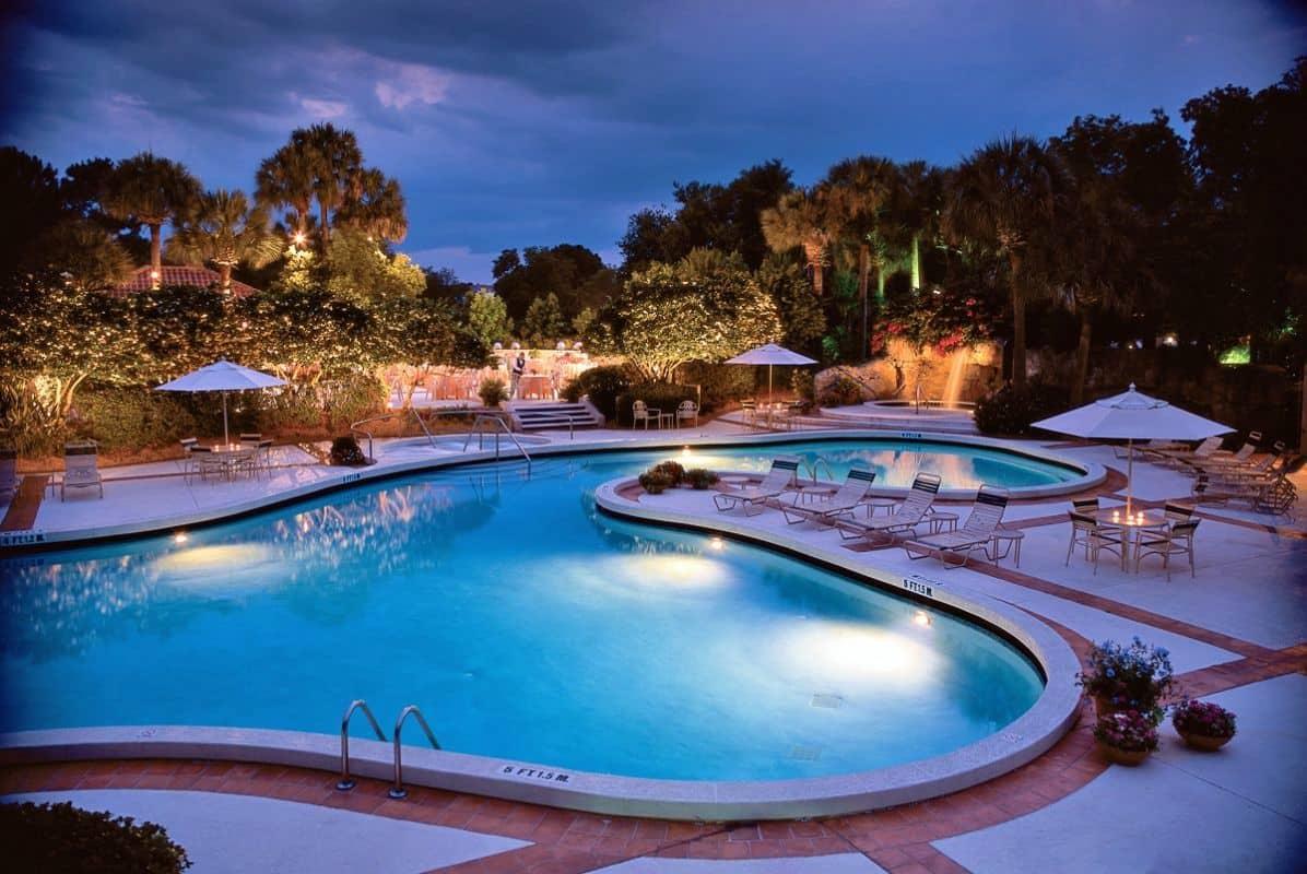 Jacuzzi, swimming pool, sunbeds and outdoor restaurant at the hotel all surrounded by palm trees