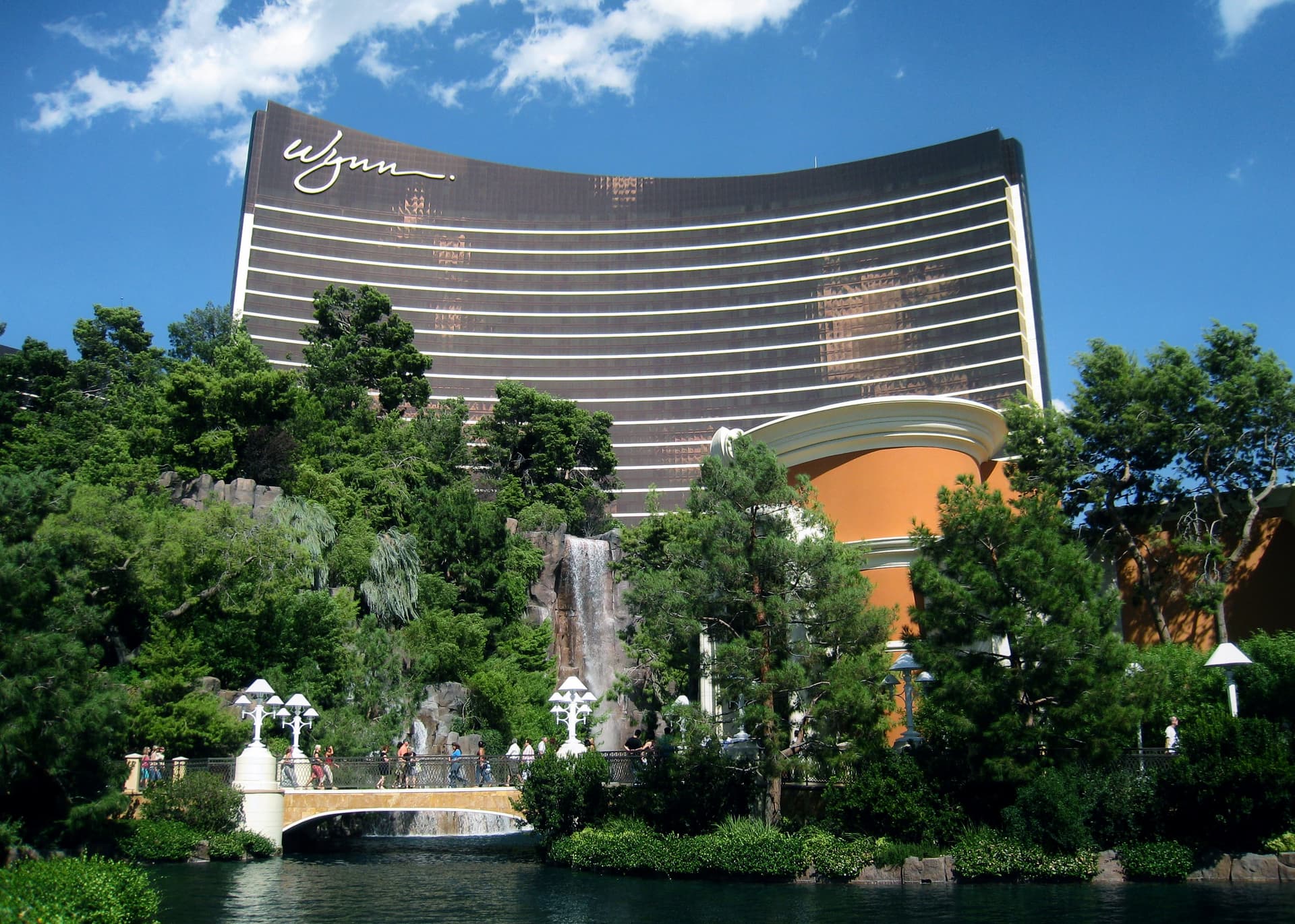 The Wynn Las Vegas hotel building towering over the surrounding trees