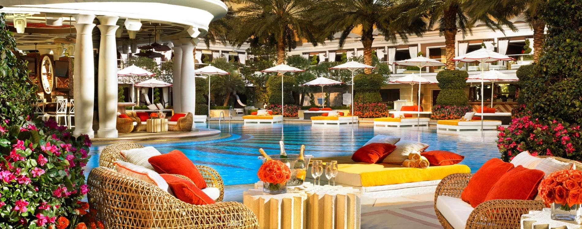 Luxury outdoor luxury swimming pool surrounded by sunbeds and cabanas