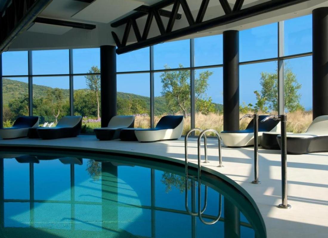Indoor swimming pool at the Argentario Golf & Wellness Resort with panoramic windows