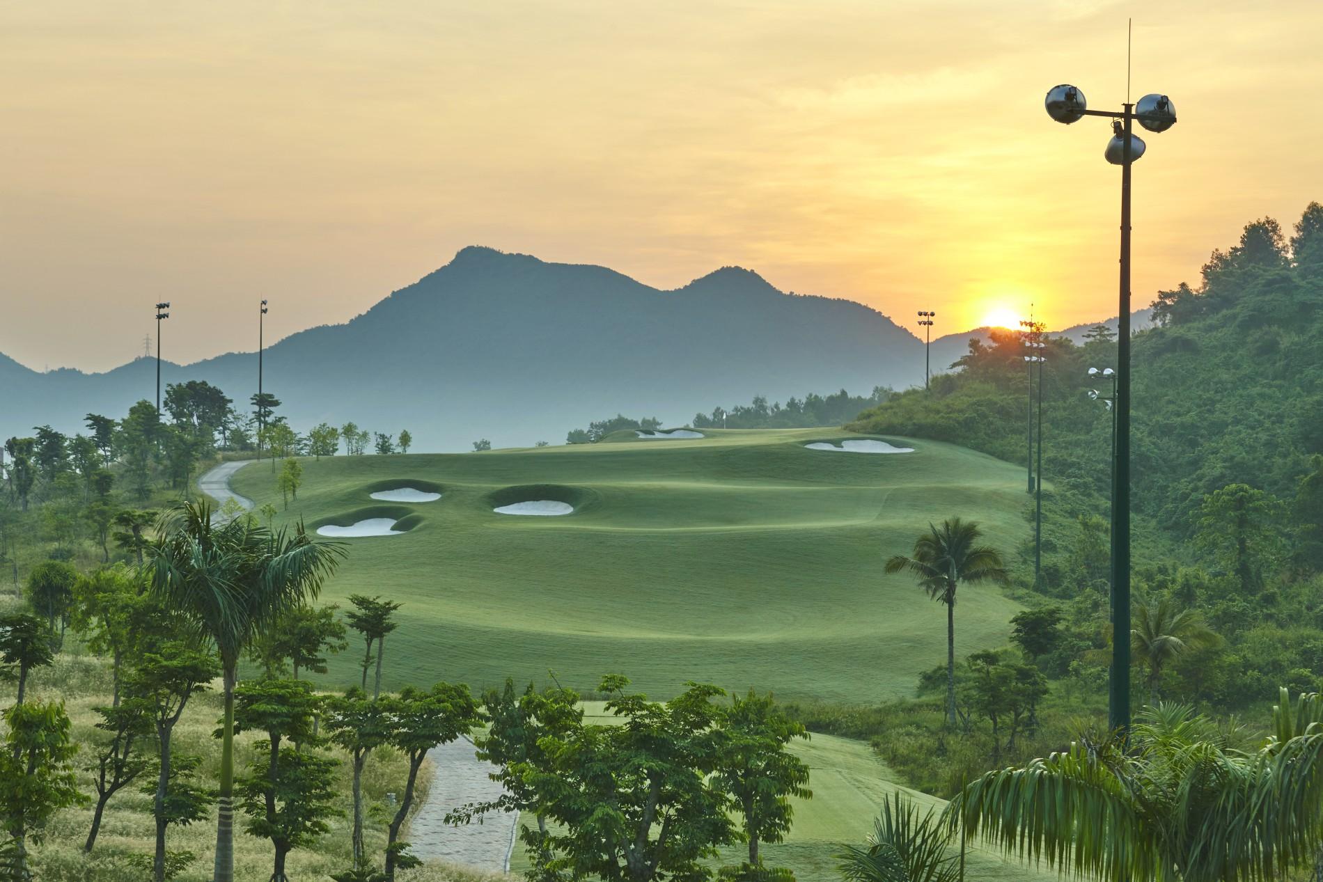 Overhead view of the sun setting over the Ba Na Hills Golf Club course