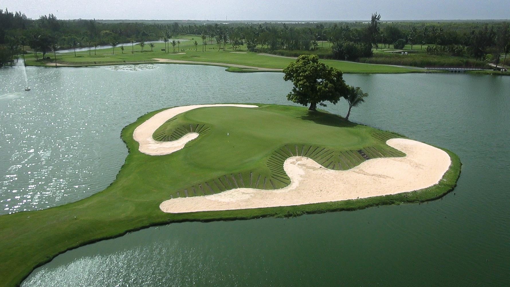 An island green surrounded by large sand bunkers