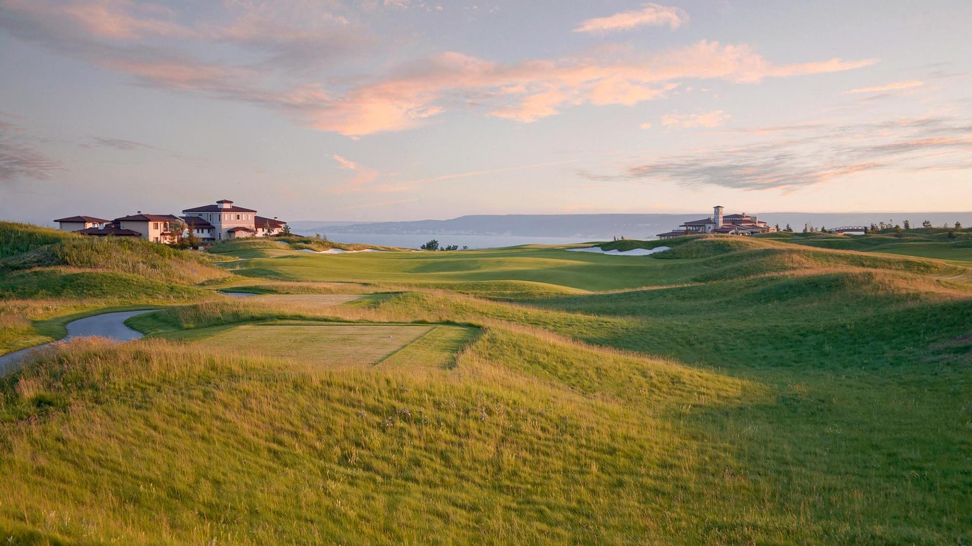Tee off into rolling dunes on the fairway with coastal views in the distance