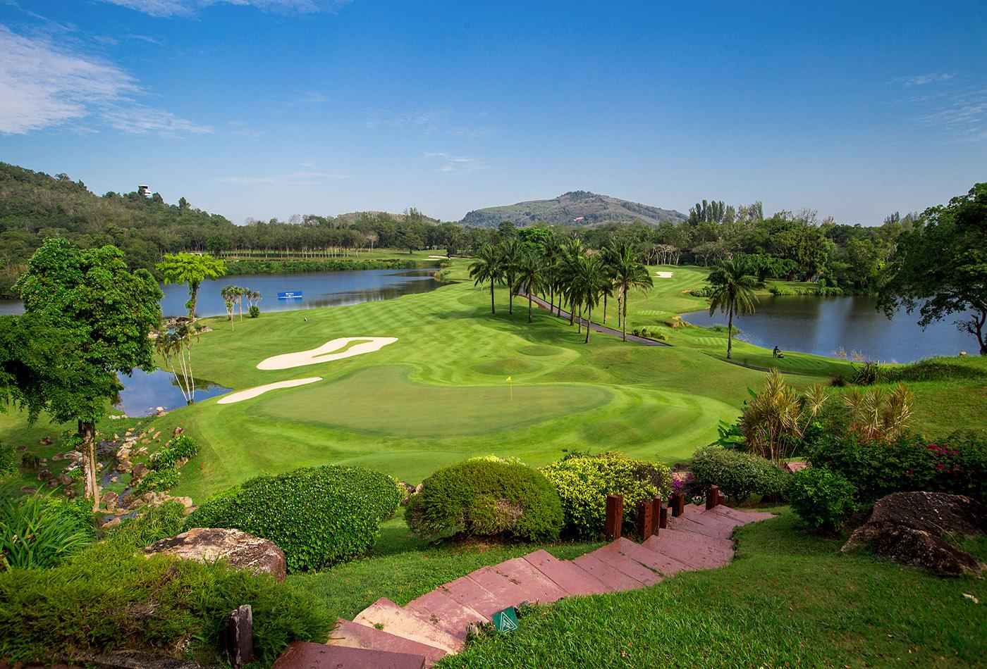 A smooth green surrounded by sand bunkers and a water hazard