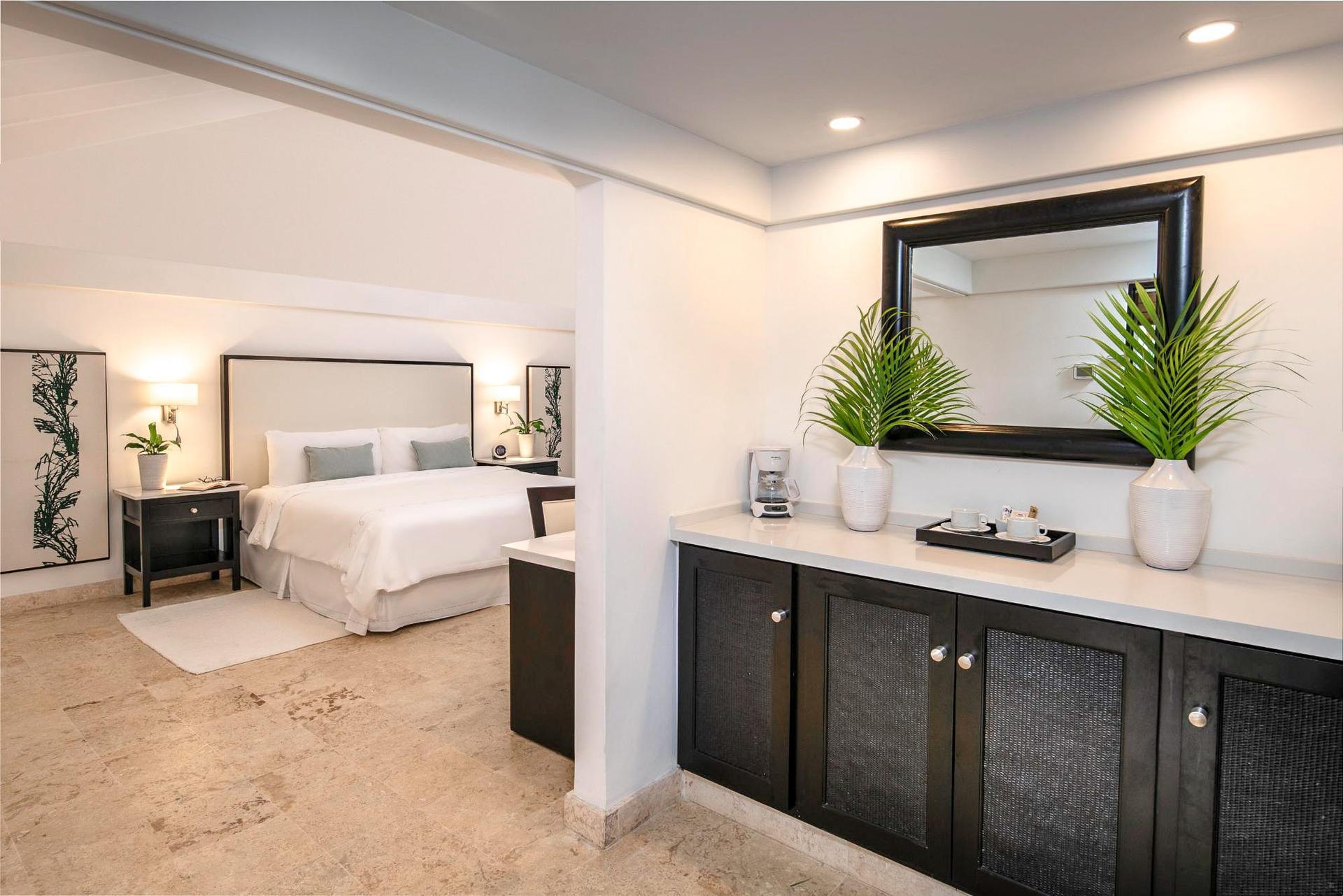 Modern double bed suite at the resort following a white and black theme