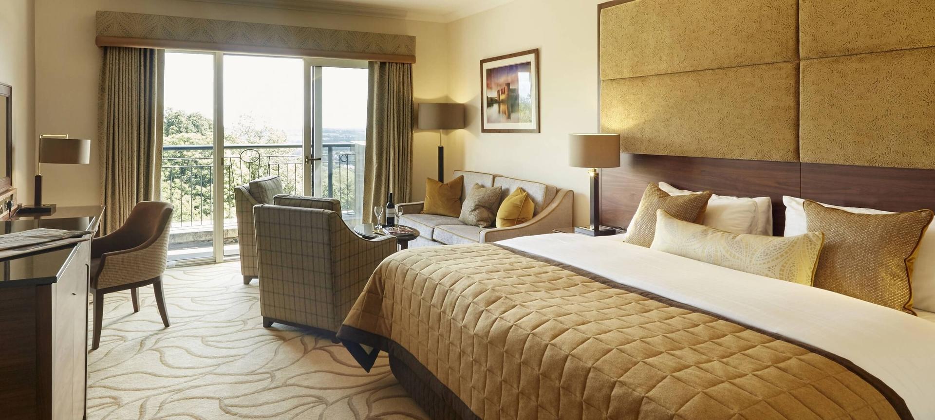 Modern bedroom with a gold and brown theme and king sized bed