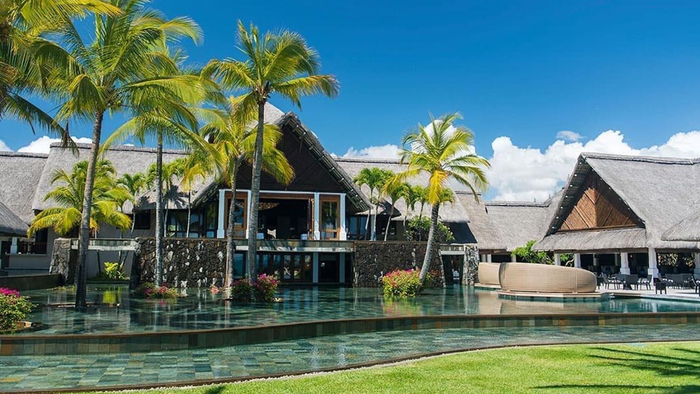 Panoramic view of the sea side resort nestled with palm trees and a water feature