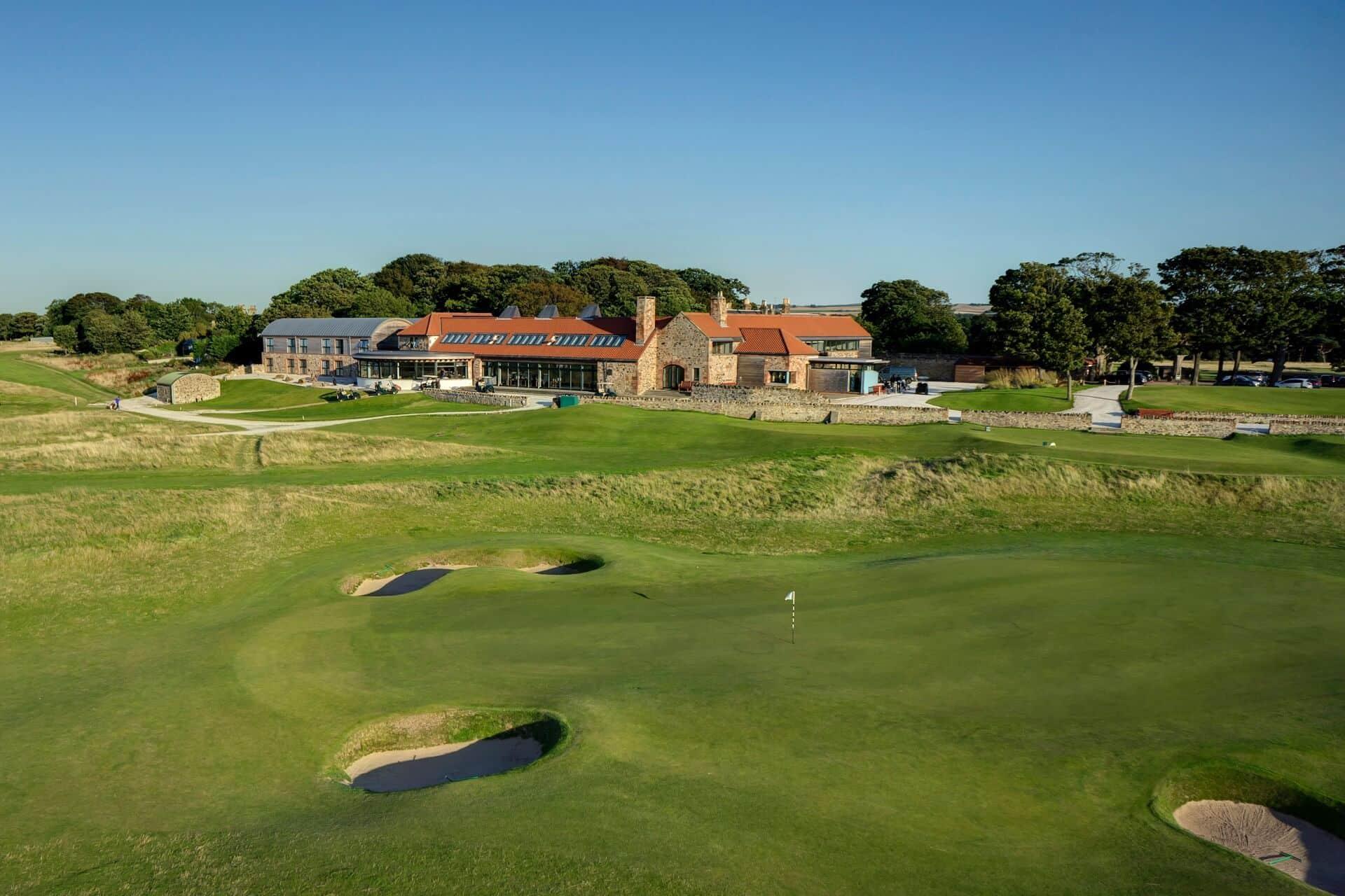 The clubhouse sits proudly above the finishing holes, blending tradition with modern luxury.