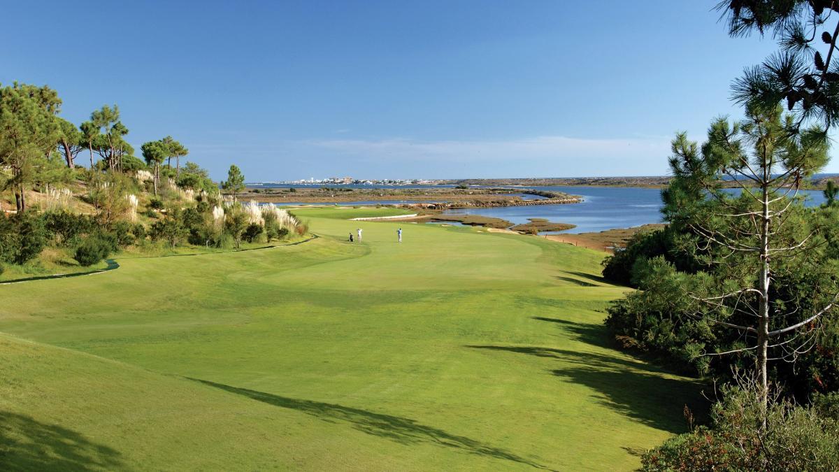 Two players playing on a winding fairway