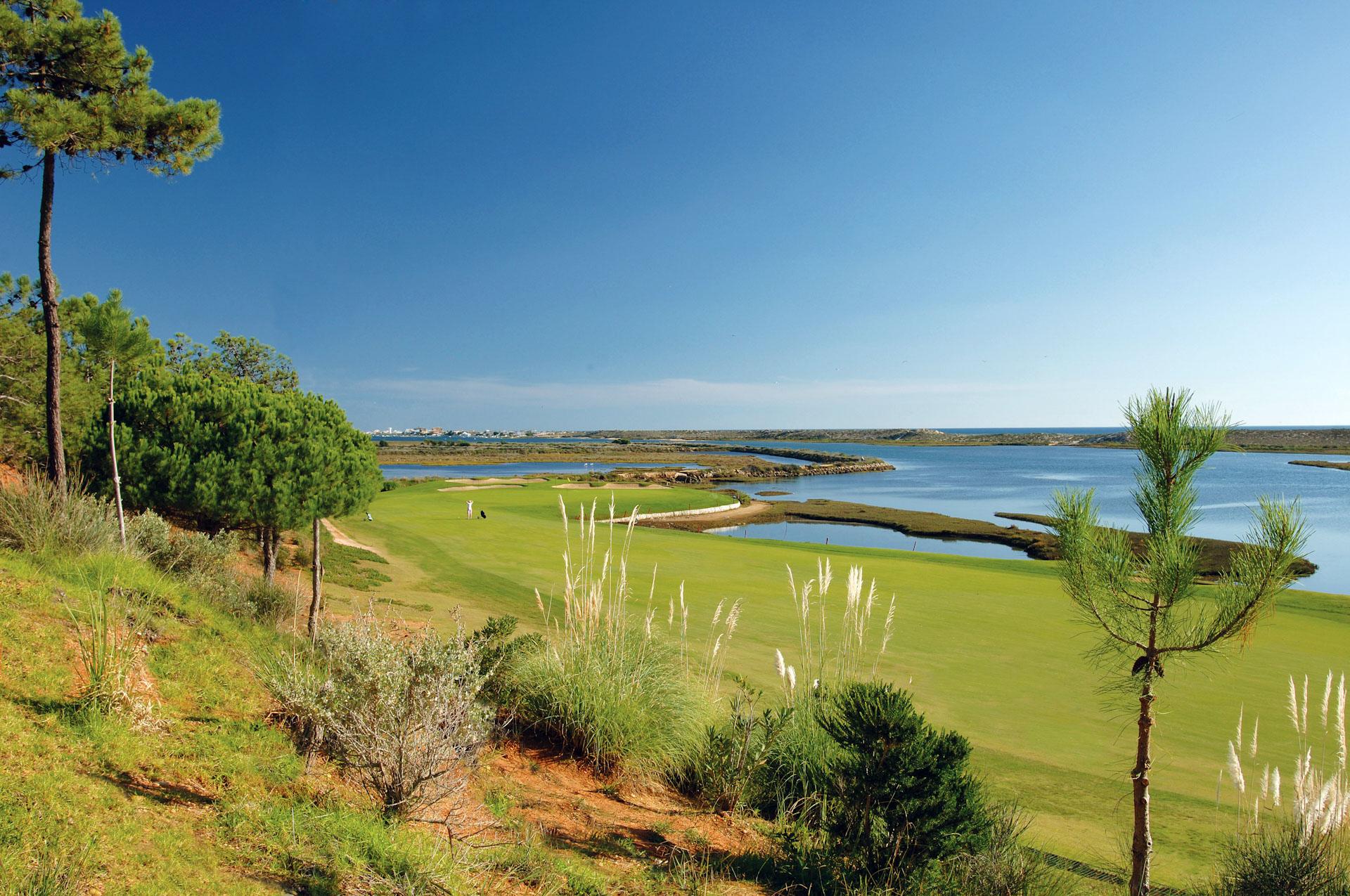 Manicured fairway with water hazard on the left
