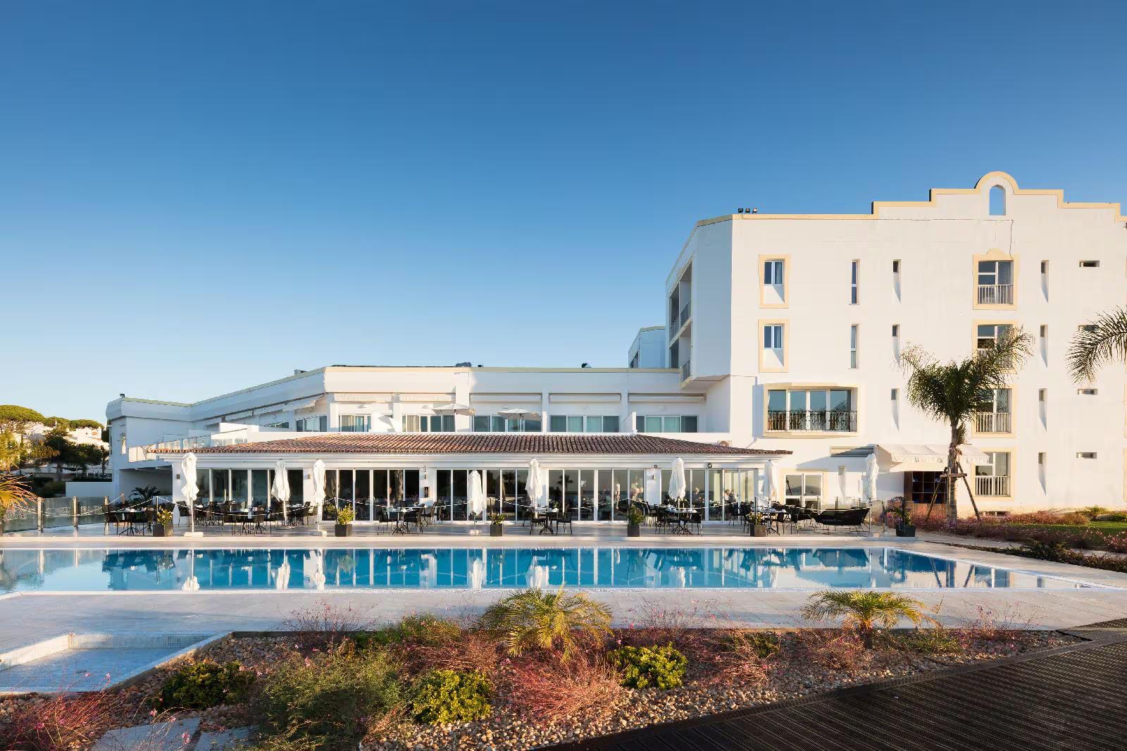 Outdoor swimming pool area overlooked by the hotel