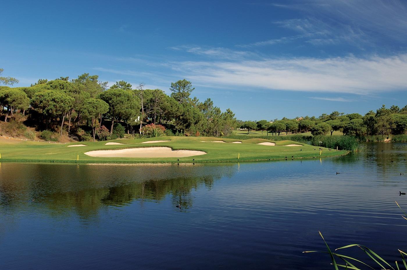 Green with bunkers and water around it