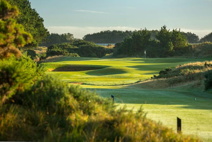 Rolling dunes at the Dondonald Links course with a deep sand bunker placed on green right next to the hole