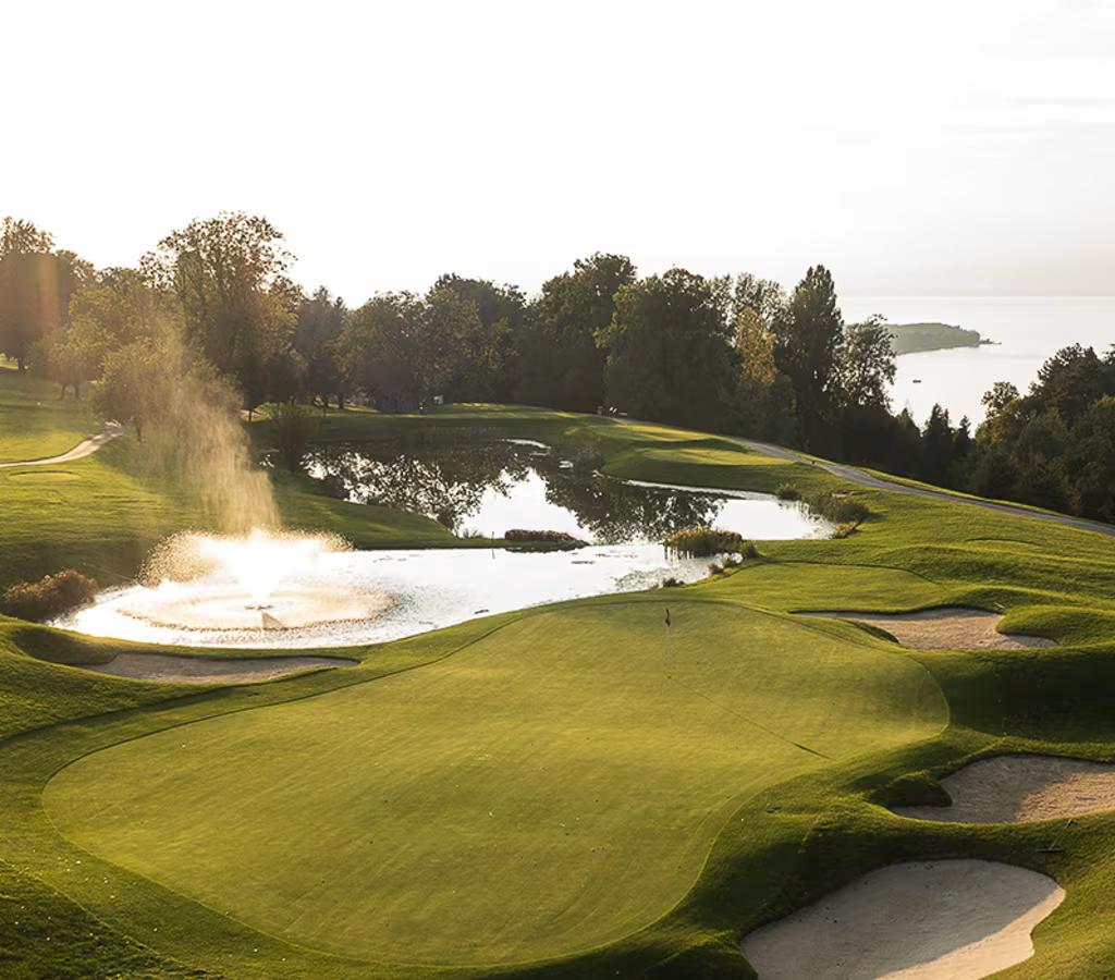 Short Par 3 over water to an undulating green