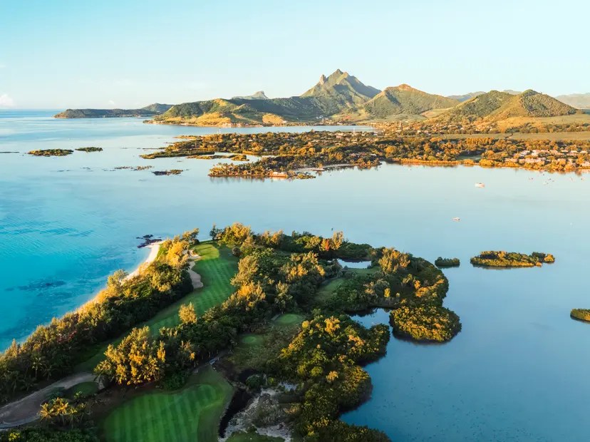 A well-maintained fairway leading to a smooth green with coastal and mountain views