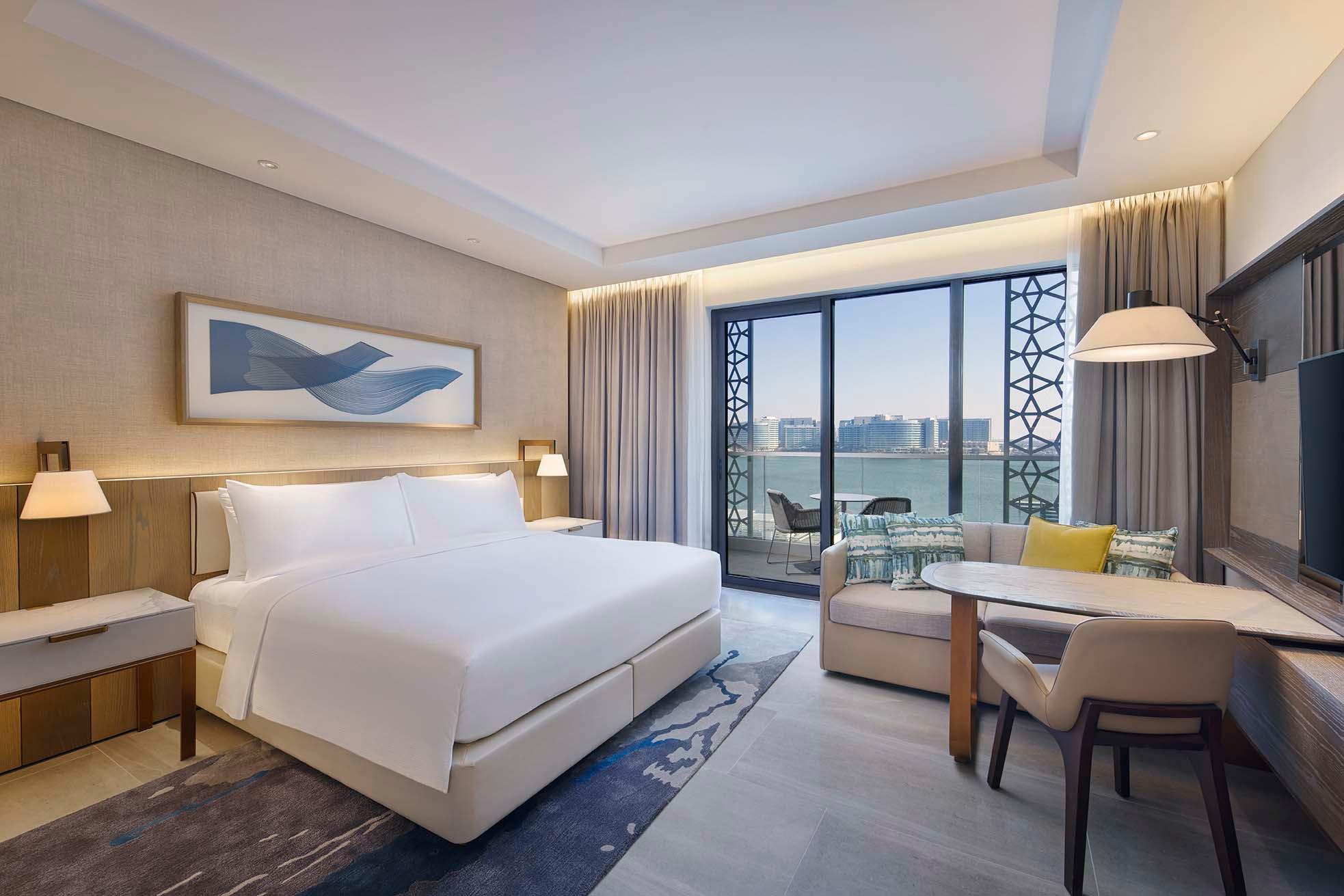 A double bed room at the hotel with balcony views of the sea