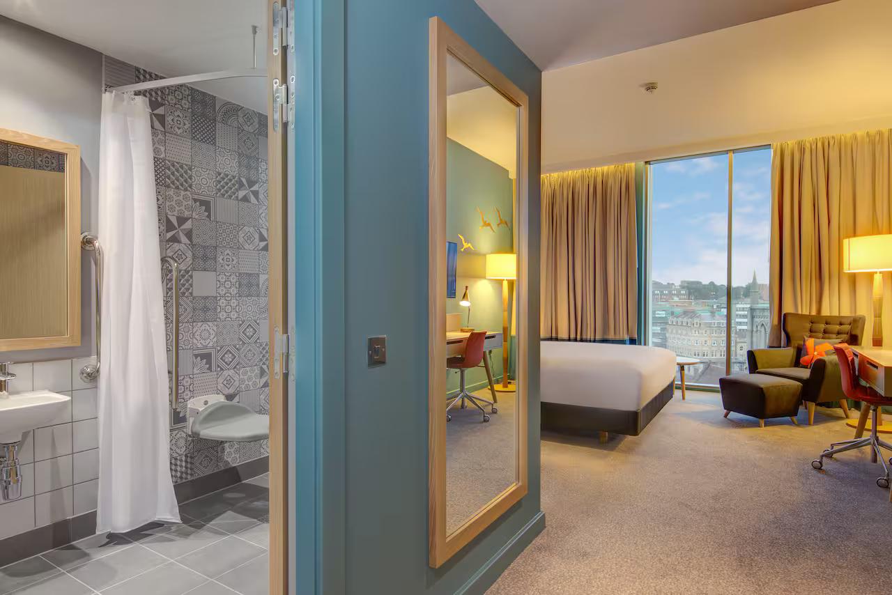 Single bed accessible suite at the Hilton with city views from the panoramic window