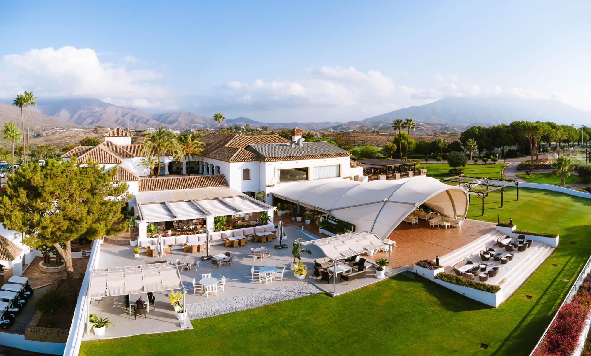 Hotel La Cala from the outside with mountains in the distance