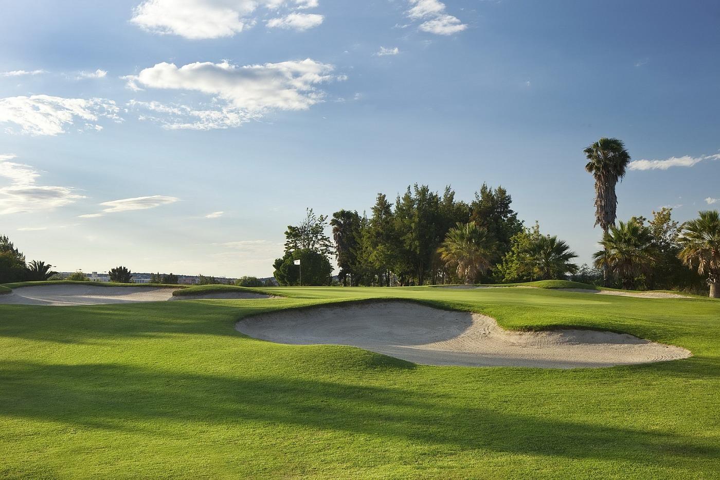 Pristine fairway leading up to the green with green side bunkers