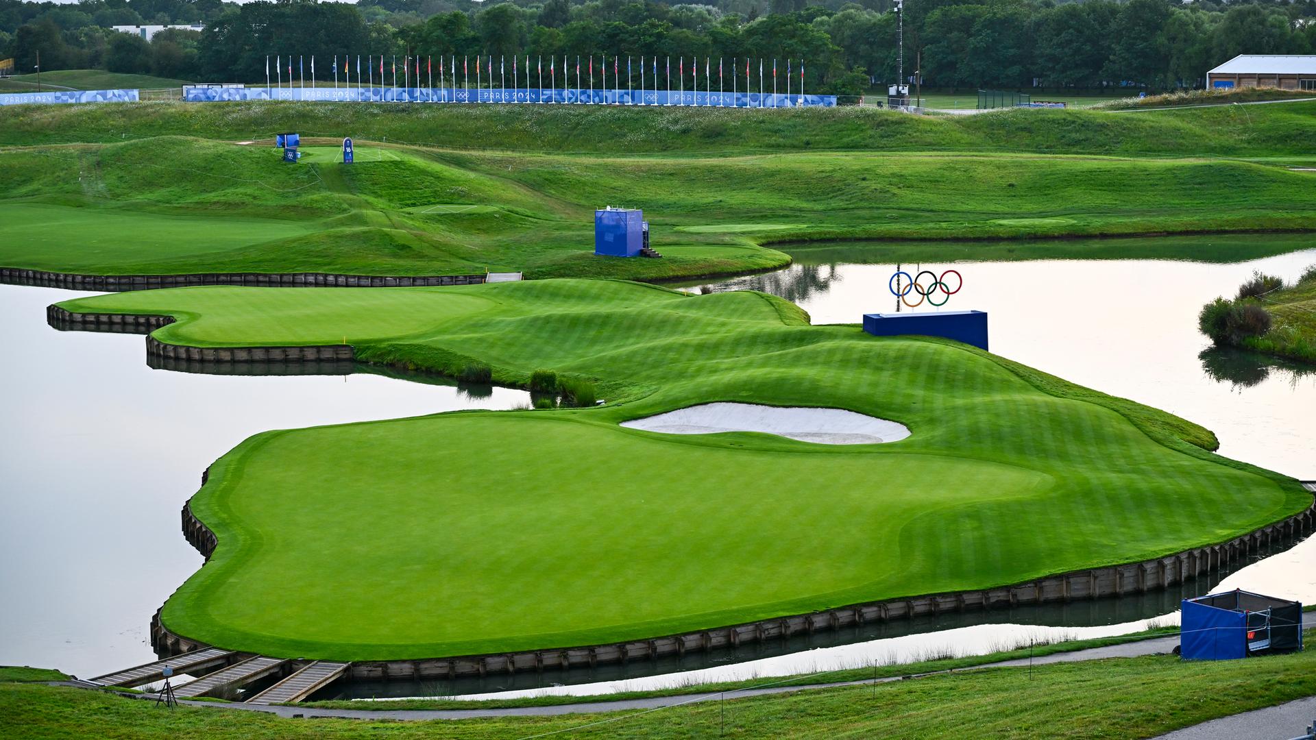 Two greens surrounded by water with the Olympic logo visible