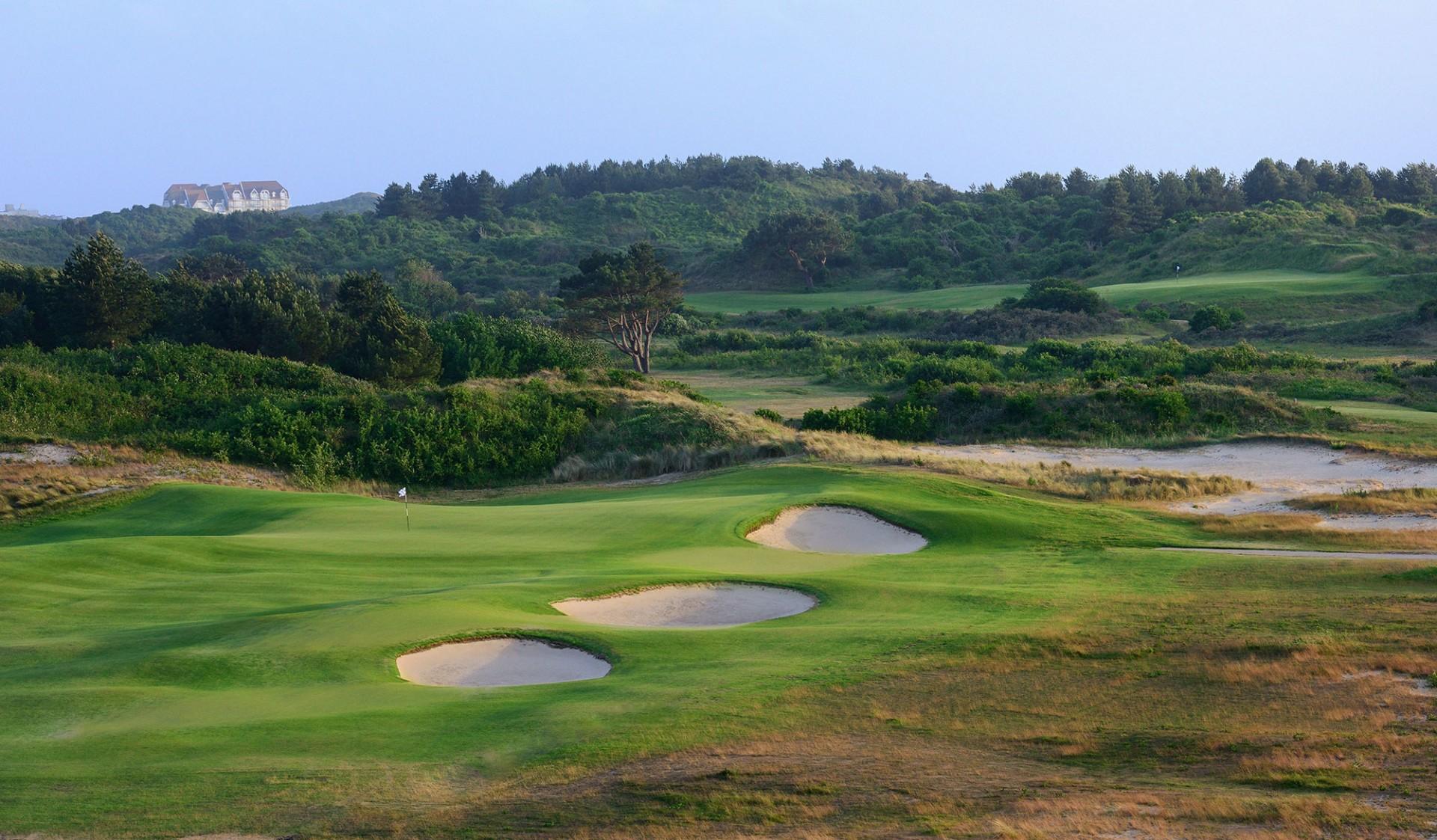 Undulating green with bunkers around
