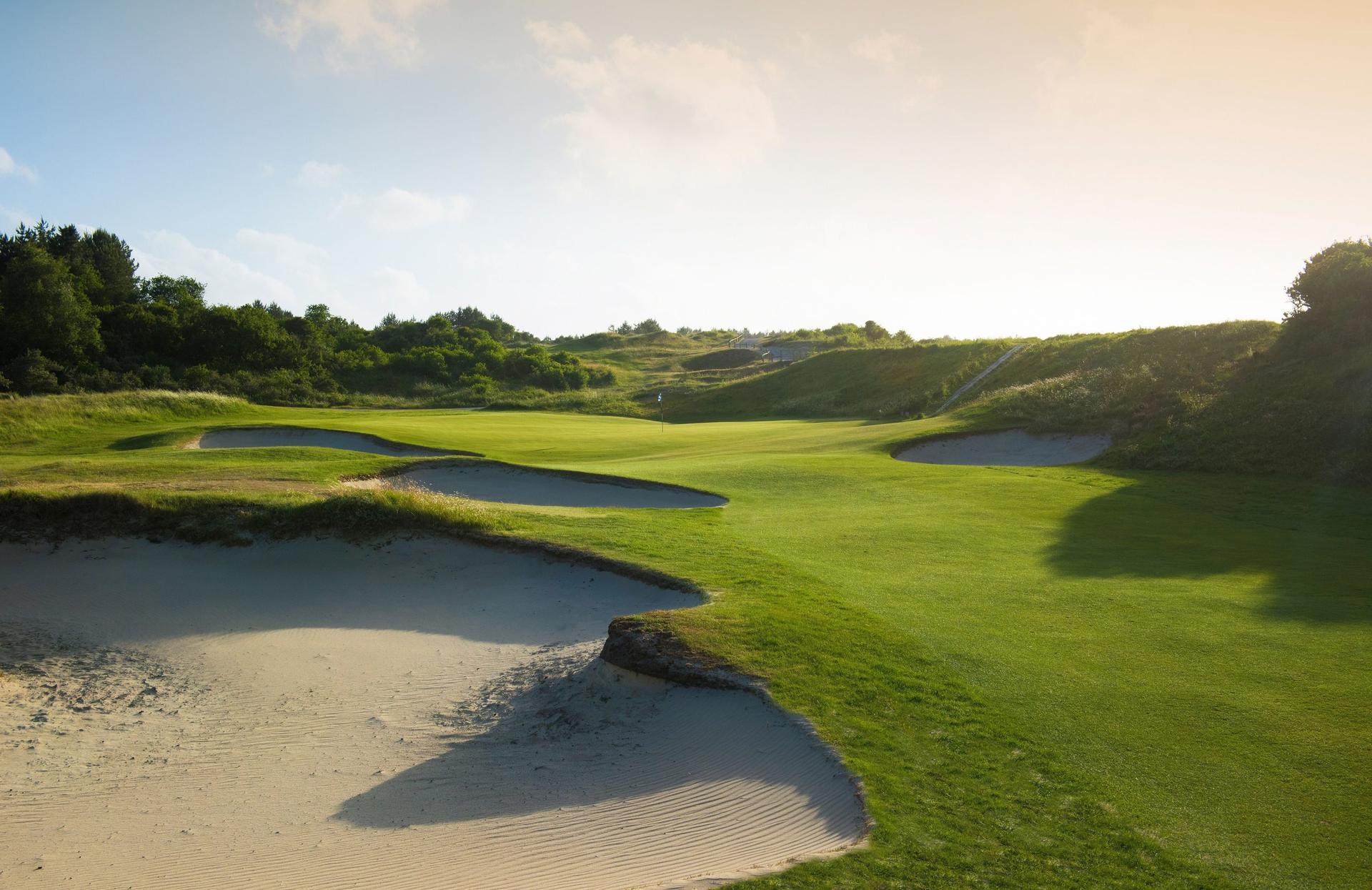 Undulating green with bunkers around