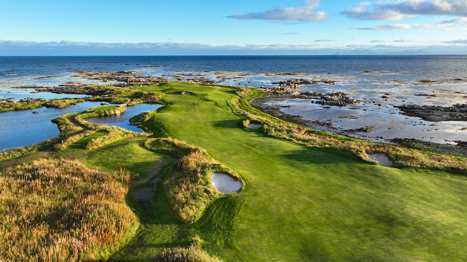 A straight fairway nestled with bunkers leading to a smooth green