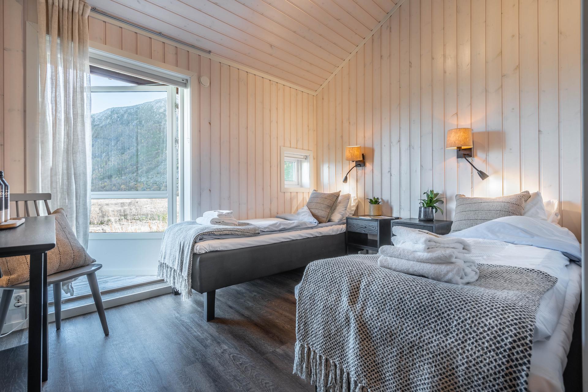 Modern twin bed room with a patio access door