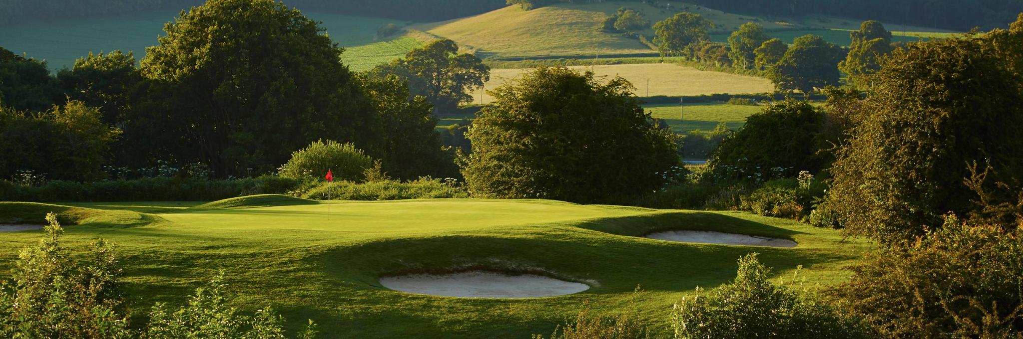 Lush greens with bunkers and a putting green