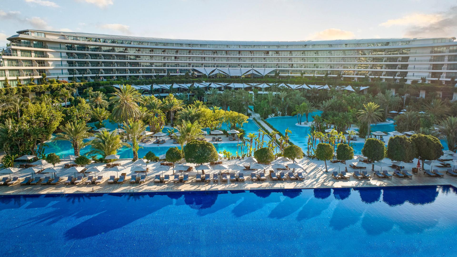 Outdoor swimming pool area overlooked by the hotel