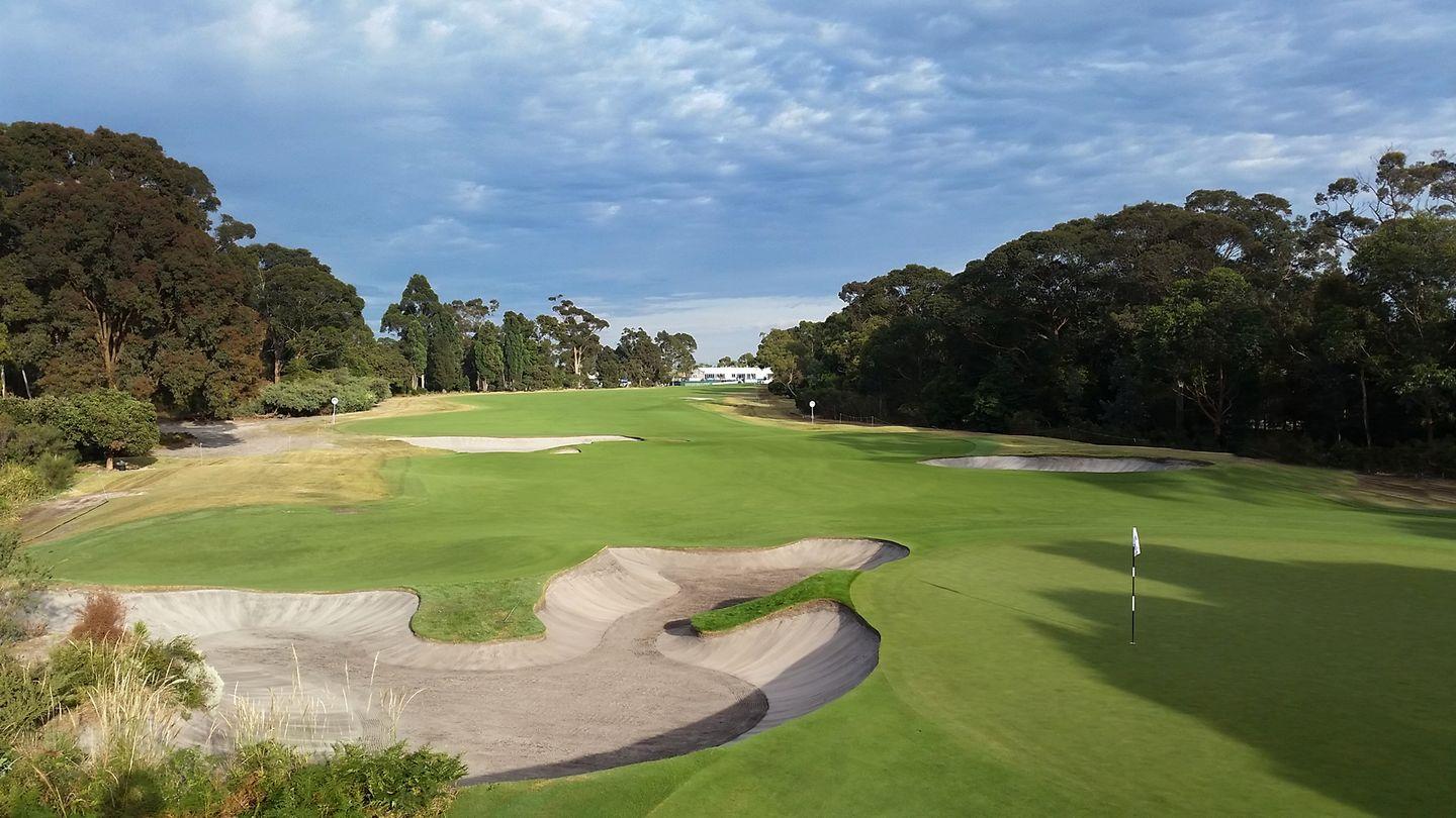 A well maintained fairway leading to a smooth green both nestled with sand bunkers