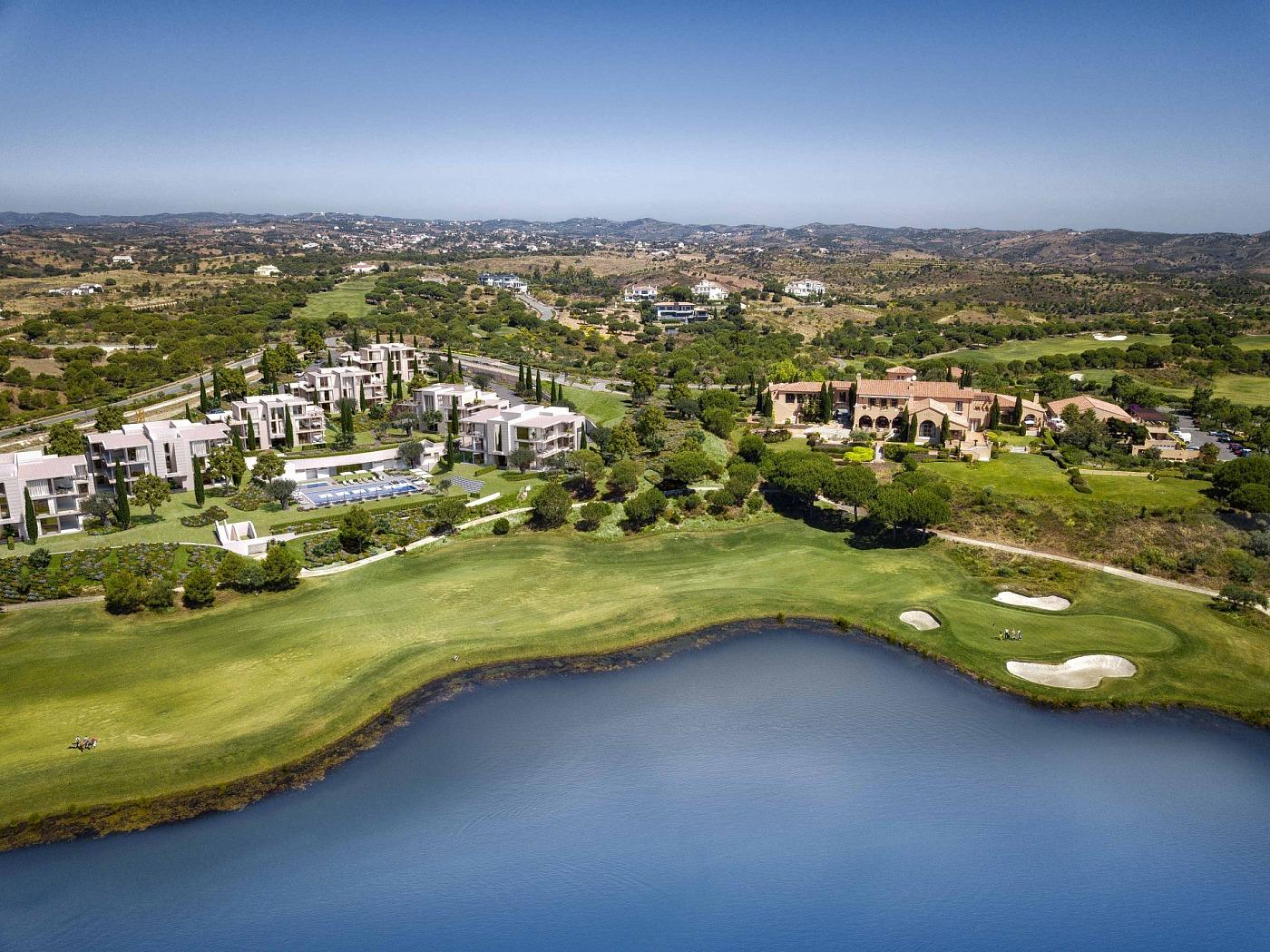 Aerial view of the course with a large water hazard running alongside a fairway