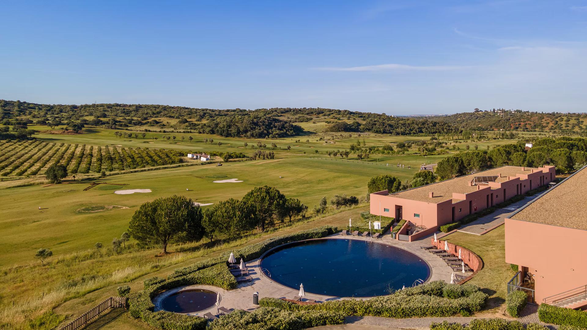 Outdoor swimming pool area adjacent to the Morgado de Reguengo Course