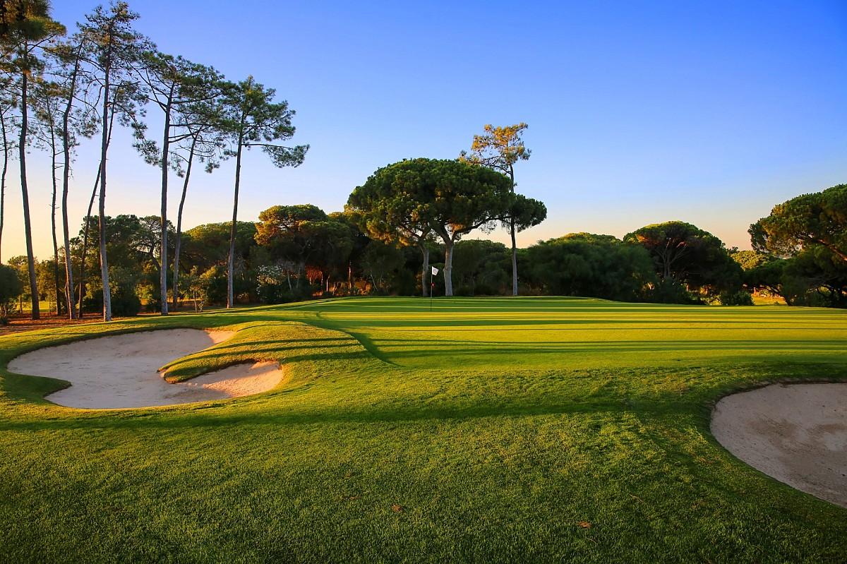 Manicured green with bunkers around it on the Old Course Vilamoura