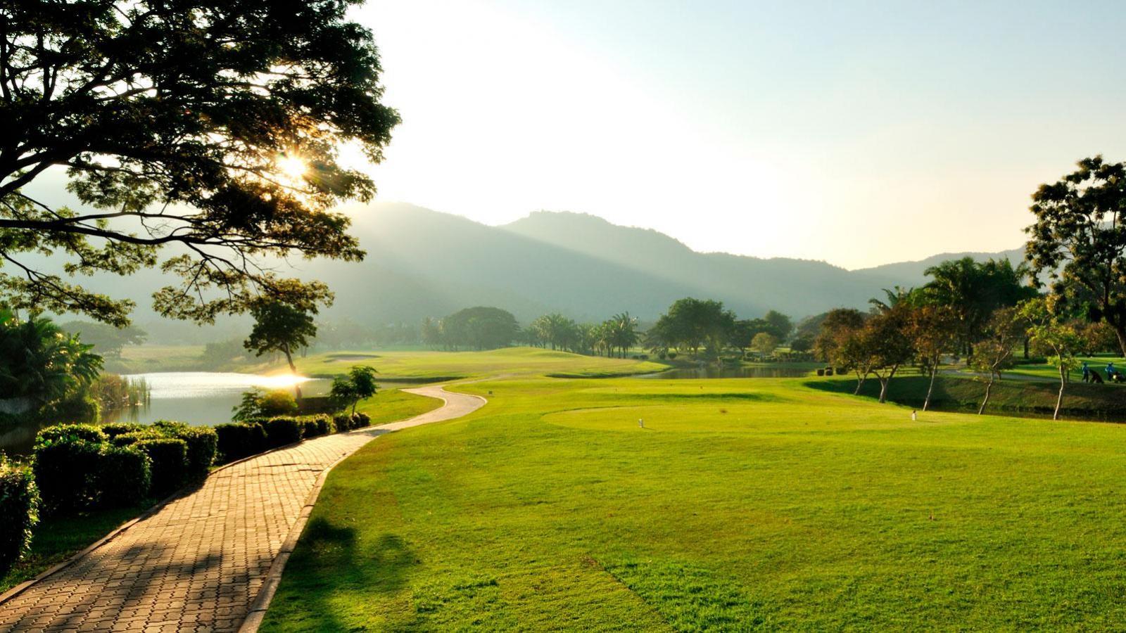 The sun shining onto a well-kept fairway on the Palm Hills course